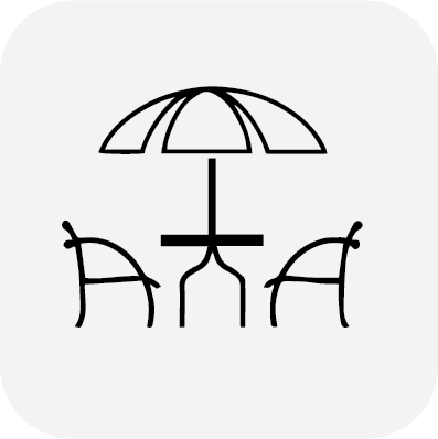 An outdoor seating icon representing alfresco dining at local pubs