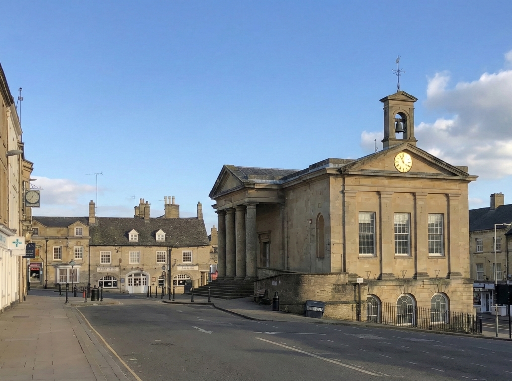 Excelsior Taxis providing reliable private hire and taxi services in Chipping Norton, pictured near the historic Town Hall.